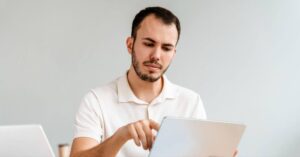 man reading information on a tablet