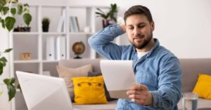 man looking at a notepad