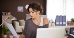 woman reading information off a piece of paper