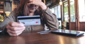 Stressed woman looking at her credit cards