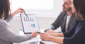 (couple looking at financial data with the help of a consultant) 